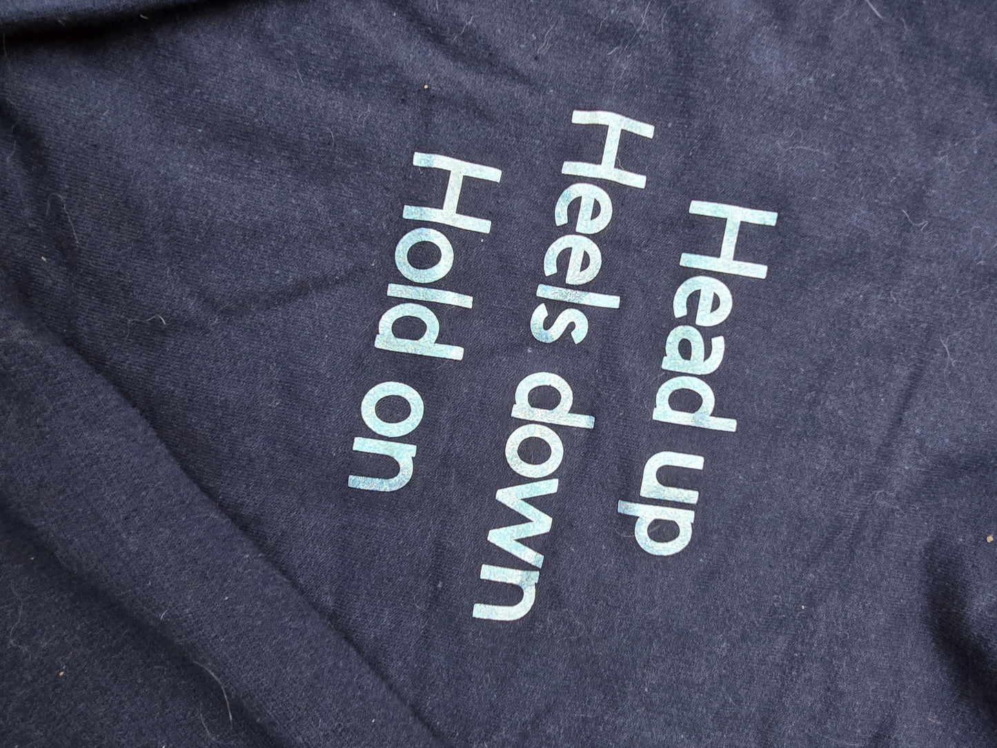 Navy hoodie "head up, heels down, hold on"